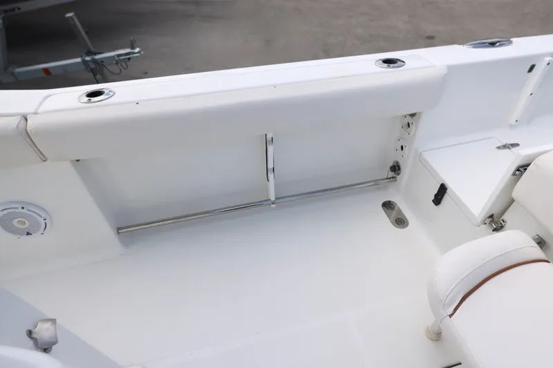 Slide: The Image of 2021 Sea Hunt Gamefish 25 boat interior with white seating and rod holders. - 12