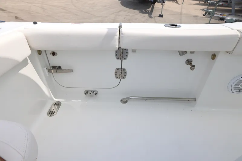 Slide: The Image of 2021 Sea Hunt Gamefish 25 boat interior, featuring white seating and stainless steel fixtures. - 14