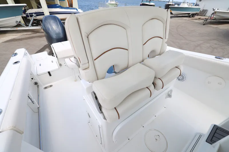 Slide: The Image of 2021 Sea Hunt Gamefish 25 boat interior with cushioned seating and storage compartments. - 15