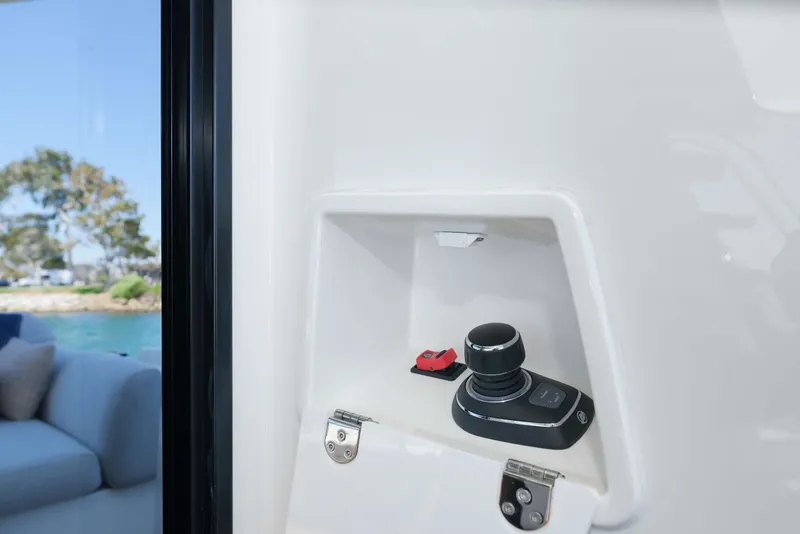 Slide: The Image of Control panel on a 2022 Prestige 590 yacht, featuring joystick and switch. - 28