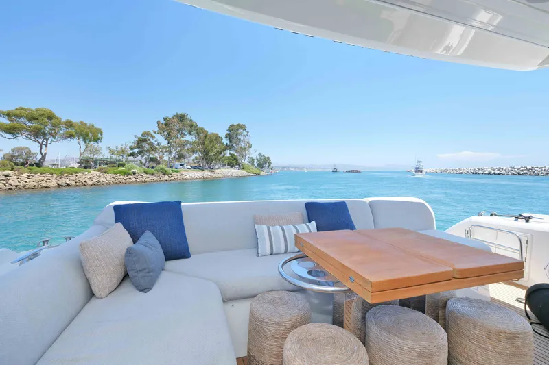 Slide: The Image of Luxurious 2022 Prestige 590 yacht with elegant seating, cruising on serene blue waters. - 30