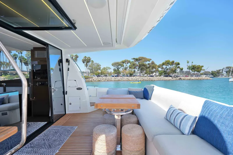 Slide: The Image of Luxurious 2022 Prestige 590 yacht with elegant outdoor seating and scenic waterfront view. - 27