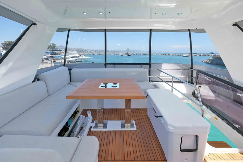 Slide: The Image of Luxurious 2022 Prestige 590 yacht interior with elegant seating and ocean view. - 19