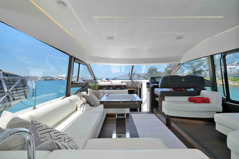 Slide: The Image of Luxurious interior of 2022 Prestige 590 yacht with modern seating and panoramic windows. - 34