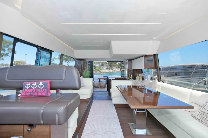 Slide: The Image of Luxurious interior of a 2022 Prestige 590 yacht with elegant seating and scenic views. - 43