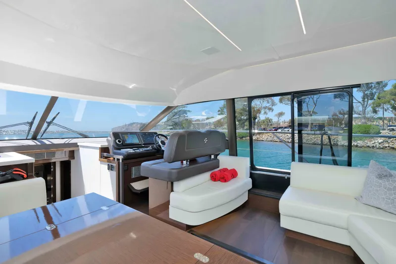 Slide: The Image of Luxurious interior of 2022 Prestige 590 yacht with modern helm and scenic water views. - 40
