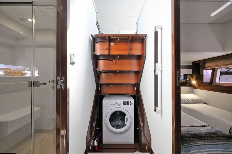 Slide: The Image of Laundry area with washing machine in 2022 Prestige 590 yacht interior. - 44