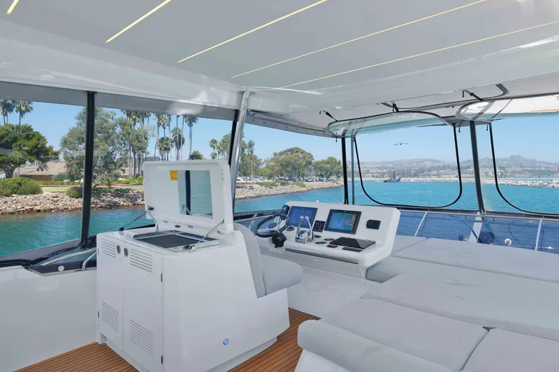 Slide: The Image of Luxurious 2022 Prestige 590 yacht interior with modern helm and scenic ocean view. - 22