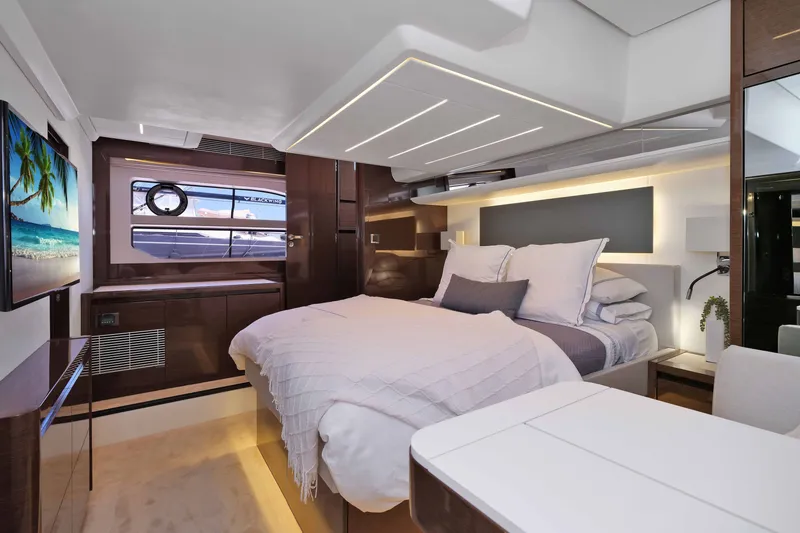 Slide: The Image of Luxurious 2022 Prestige 590 yacht bedroom with modern decor and ocean view. - 52