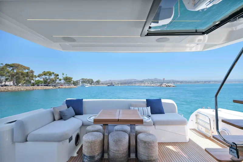 Slide: The Image of Luxurious 2022 Prestige 590 yacht deck with elegant seating and ocean view. - 29