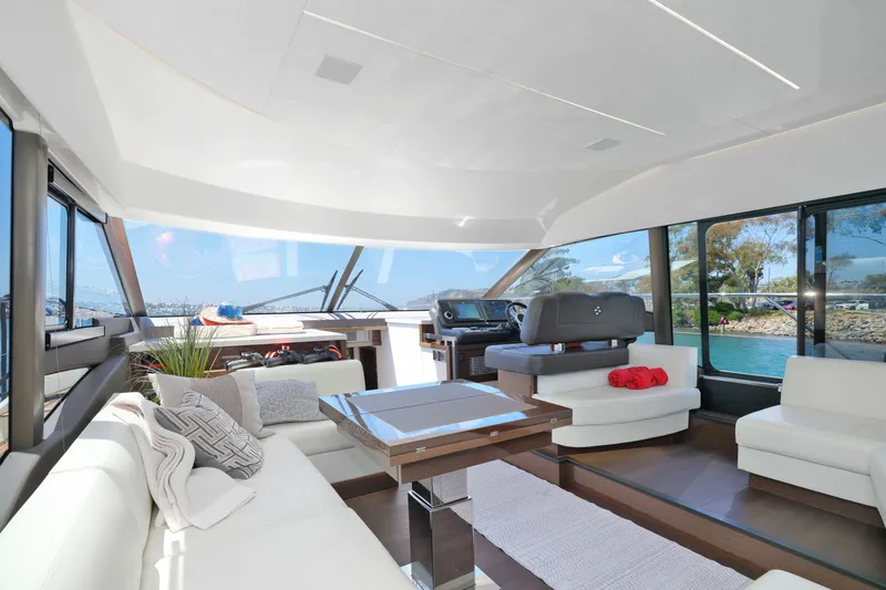 Slide: The Image of Luxurious interior of 2022 Prestige 590 yacht with modern furnishings and panoramic windows. - 39