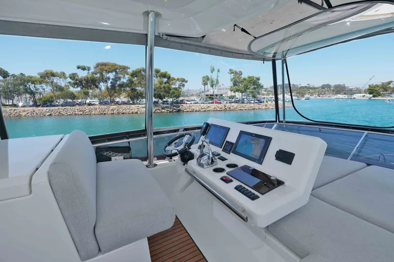 Slide: The Image of Luxurious 2022 Prestige 590 yacht helm with modern navigation systems, overlooking serene marina waters. - 23