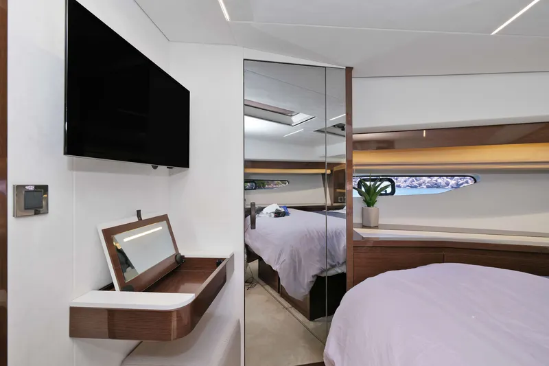 Slide: The Image of Luxurious 2022 Prestige 590 yacht bedroom with modern decor and large mirror. - 47