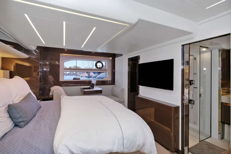 Slide: The Image of Luxurious 2022 Prestige 590 yacht bedroom with modern decor and marina view. - 54