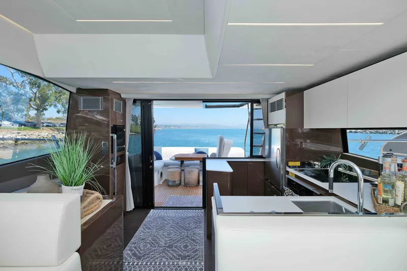 Slide: The Image of Luxurious 2022 Prestige 590 yacht interior with modern kitchen and stunning ocean view. - 38