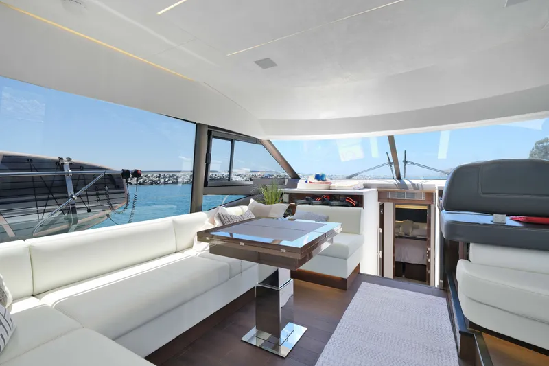 Slide: The Image of Luxurious interior of 2022 Prestige 590 yacht with elegant seating and panoramic windows. - 36