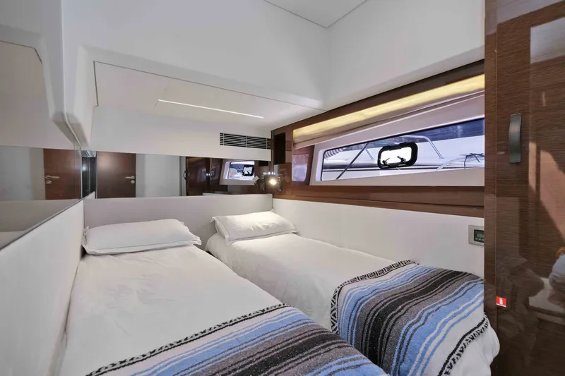 Slide: The Image of Luxurious twin cabin interior on a 2022 Prestige 590 yacht, featuring modern design and comfort. - 60