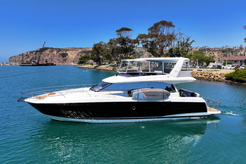Slide: The Image of Luxury 2022 Prestige 590 yacht cruising in scenic coastal waters. - 7