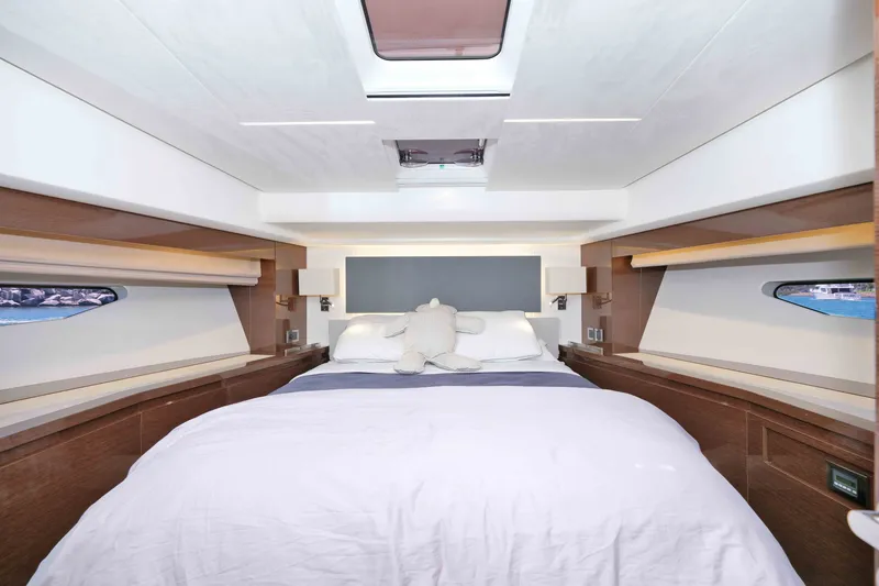 Slide: The Image of Luxurious bedroom interior of 2022 Prestige 590 yacht with elegant design and natural light. - 45