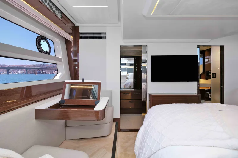 Slide: The Image of Luxurious 2022 Prestige 590 yacht interior with elegant bedroom and scenic ocean view. - 55
