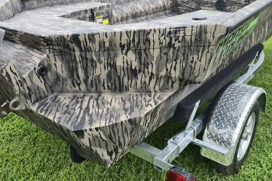 Slide: The Image of Camouflage-patterned 2027 Havoc 1656 MRST MACH 1 boat on a trailer, parked on grass. - 13