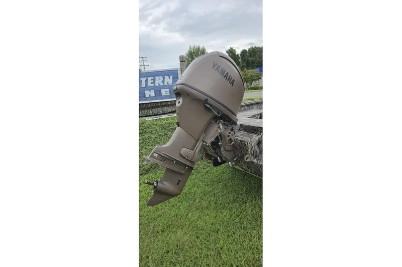 Slide: The Image of Outboard motor on a 2027 Havoc 1656 MRST MACH 1 boat, displayed on grass. - 2