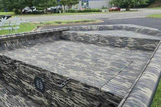 Slide: The Image of 2027 Havoc 1656 MRST MACH 1 boat with camouflage pattern in a parking lot. - 8