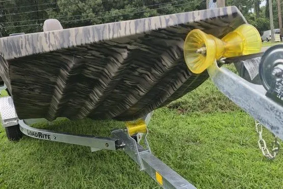 Slide: The Image of 2027 Havoc 1656 MRST MACH 1 boat on Load Rite trailer, grassy background. - 9