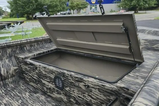 Slide: The Image of 2027 Havoc 1656 MRST MACH 1 boat with open storage compartment, camo design. - 6