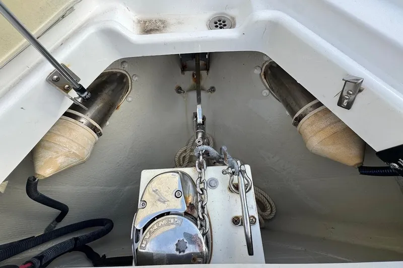 Slide: The Image of Anchor compartment of a 2018 Cobalt 30SC boat, featuring winch and chain. - 28