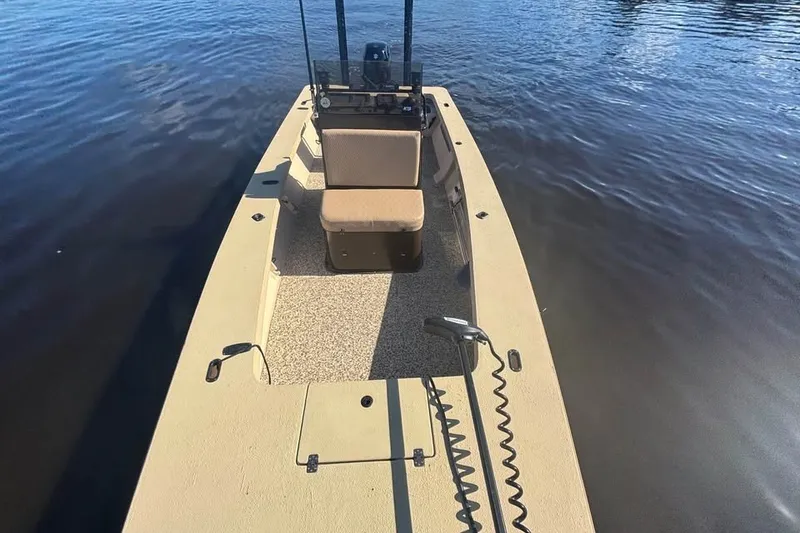 Slide: The Image of 2024 Jones Brothers Bateau 20 boat on calm water, showcasing deck and seating. - 1