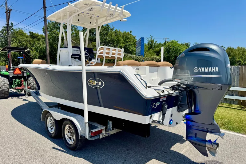 Slide: The Image of 2017 Sea Hunt Ultra 225 boat with Yamaha engine on trailer, parked outdoors. - 2