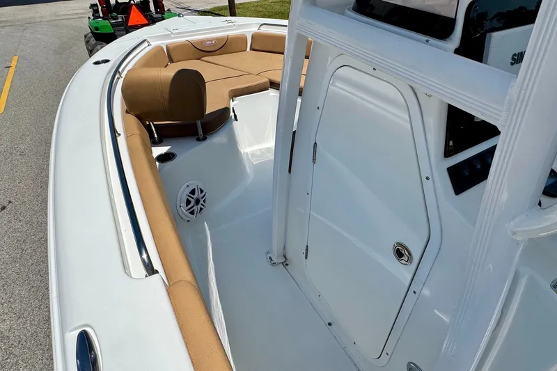 Slide: The Image of 2017 Sea Hunt Ultra 225 boat interior with tan seating and white console. - 12