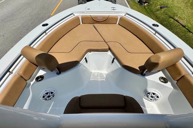 Slide: The Image of 2017 Sea Hunt Ultra 225 boat interior with tan cushioned seating and speakers. - 14