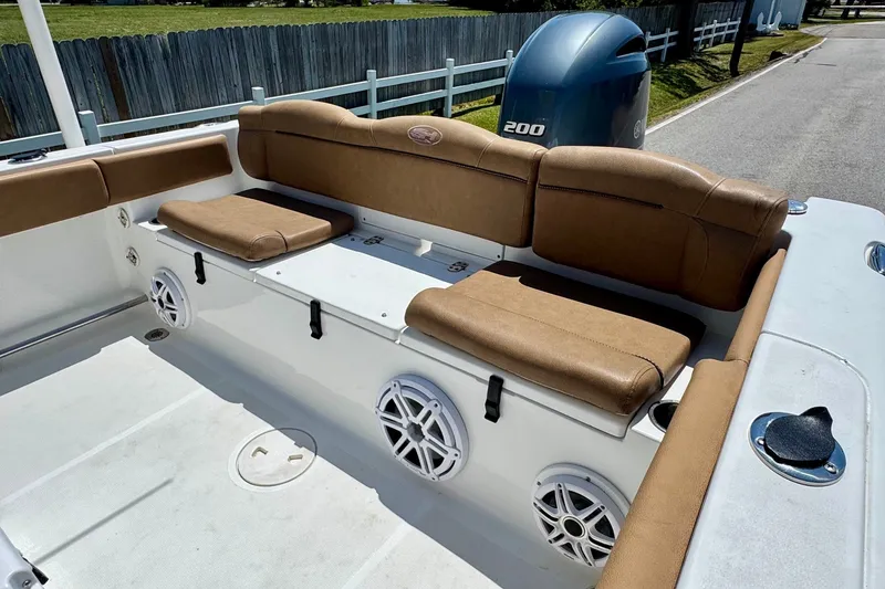 Slide: The Image of 2017 Sea Hunt Ultra 225 boat interior with tan seating and speakers. - 7