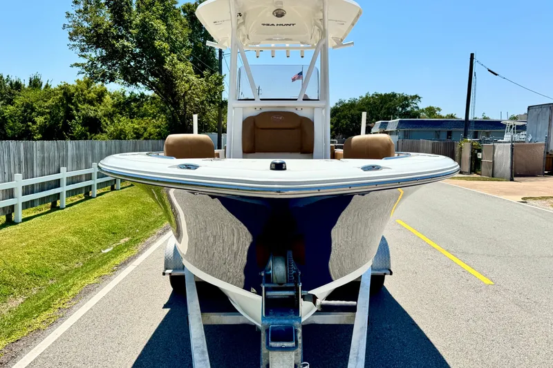 Slide: The Image of 2017 Sea Hunt Ultra 225 boat on trailer, parked on a sunny street. - 6