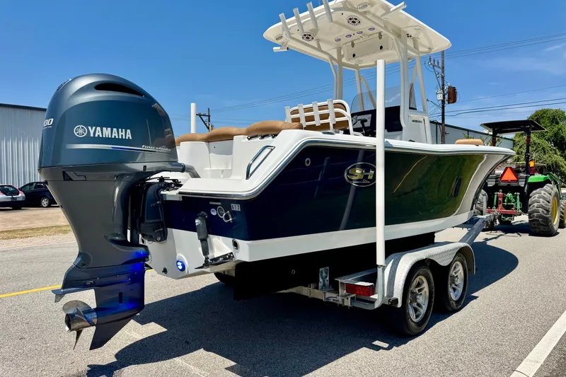 Slide: The Image of 2017 Sea Hunt Ultra 225 boat with Yamaha engine on trailer, parked outdoors. - 4