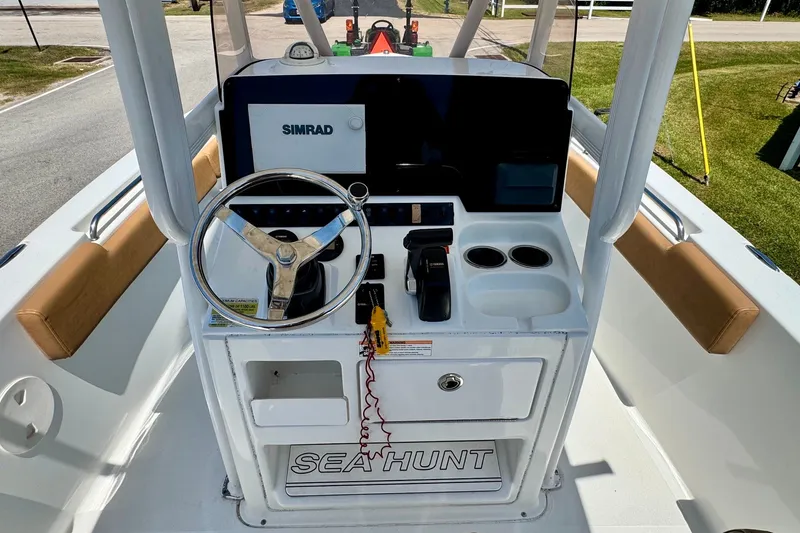 Slide: The Image of 2017 Sea Hunt Ultra 225 boat console with steering wheel and Simrad display. - 10