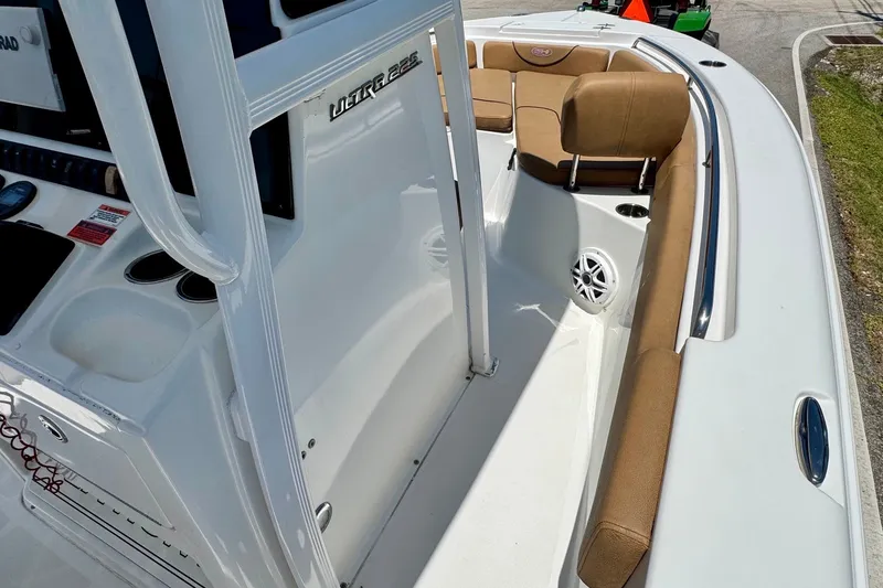 Slide: The Image of 2017 Sea Hunt Ultra 225 boat interior with tan seating and white deck. - 15