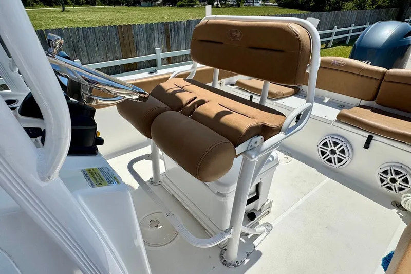Slide: The Image of 2017 Sea Hunt Ultra 225 boat interior with tan seating and steering wheel. - 9