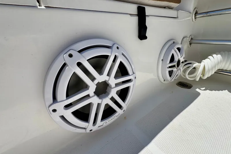 Slide: The Image of 2017 Sea Hunt Ultra 225 boat speakers and coiled hose on deck. - 19