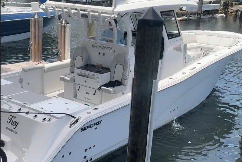 Slide: The Image of 2023 Sea Fox 368 Commander boat docked in marina, showcasing sleek design and spacious deck. - 1