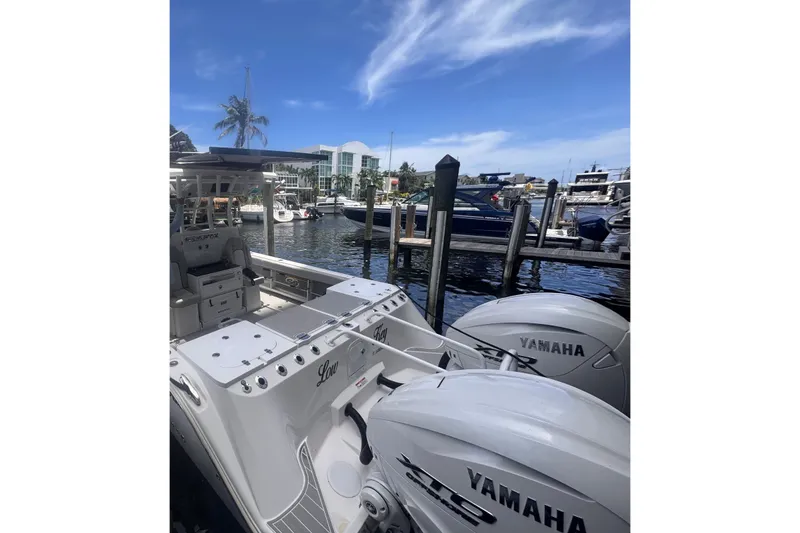 Slide: The Image of 2023 Sea Fox 368 Commander docked with Yamaha engines, under a clear blue sky. - 42