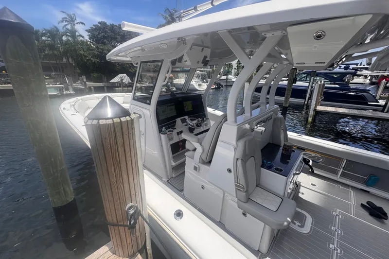 Slide: The Image of 2023 Sea Fox 368 Commander boat docked, showcasing helm and seating area. - 55