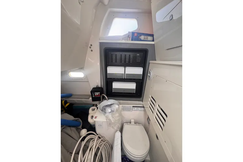 Slide: The Image of Interior of 2023 Sea Fox 368 Commander boat featuring a compact bathroom setup. - 22