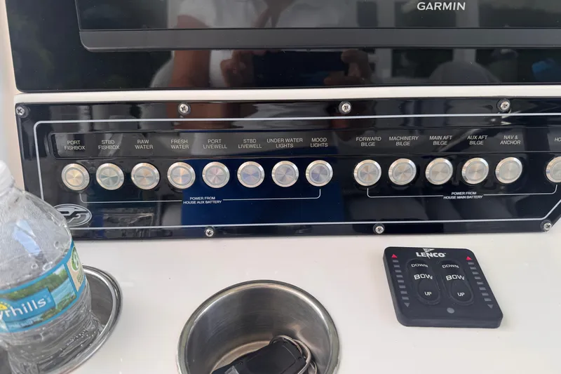 Slide: The Image of Control panel of 2023 Sea Fox 368 Commander boat with labeled switches and Lenco control. - 11