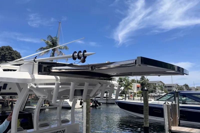 Slide: The Image of 2023 Sea Fox 368 Commander boat docked, showcasing sleek design and advanced features under a clear sky. - 36