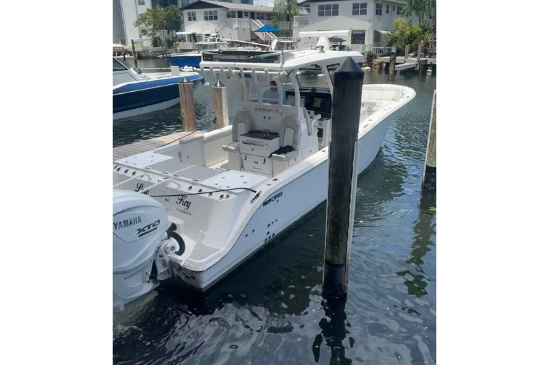 Slide: The Image of 2023 Sea Fox 368 Commander boat docked in marina, featuring Yamaha XTO engine. - 61