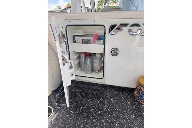 Slide: The Image of Open storage compartment on 2023 Sea Fox 368 Commander boat, containing various items. - 31