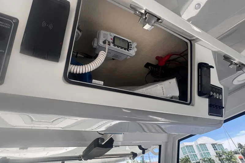 Slide: The Image of 2023 Sea Fox 368 Commander boat console with electronic equipment and storage compartment. - 17